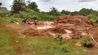 Child in a mercury polluted pond of water