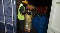 Port's employee working during the inspection of the container