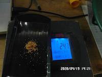 2.47 grams of the gold on the balance scale