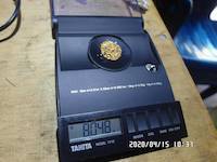 8.048 grams of natural gold nuggets on the balance scale
