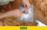 Crushing rocks with hammer on a metallic surface