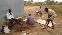 Workers preparing the improvized wooden table