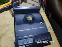 2.4 grams of natural gold nuggets on the balance scale