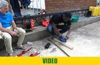 Apprentice in Start Your Own Gold Mine program practicing how to mount metal parts of the pickaxe onto its handles