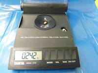 0.242 grams of gold nugget on the scale