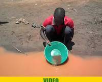 Mr. Tibasima, gold panning for gold at river Okame, near Amonikakinei, Uganda