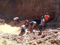 Ugandan miners panning for a rich gold ore
