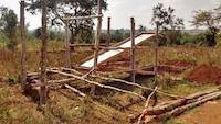 Preparation of rudimentary sluice for ore processing in Uganda