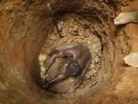 Small scale miner in the pit, excavating gold ore, Banso, Ghana