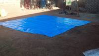 The square plastic canvas prepared on ground for sample mixing