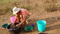 Mr. Louis doing practical field assay of gold