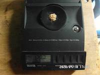 That is how 1.28 grams of gold look like on the balance scale