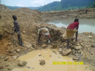Children washing surplus ore for gold