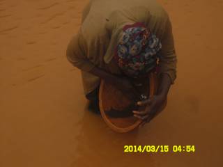 Miner panning for gold in Ghana