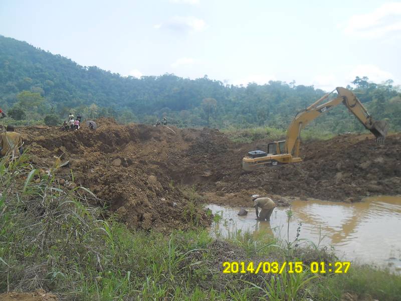 Miner panning for gold in the dam in Ghana