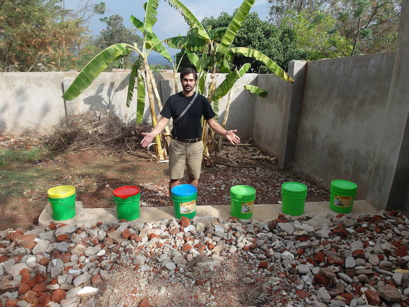 Mr. Jean Louis in front of buckets without gold