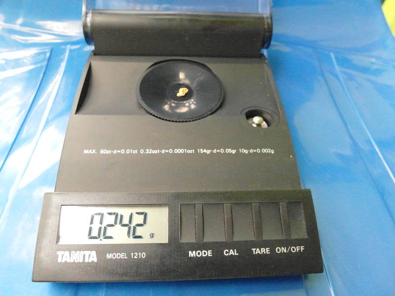 0.242 grams of gold nugget on the scale