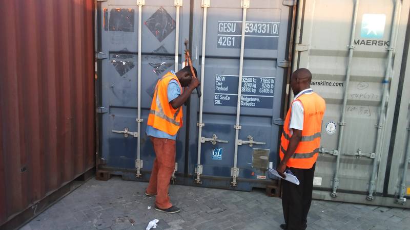 Port's employees opening the container