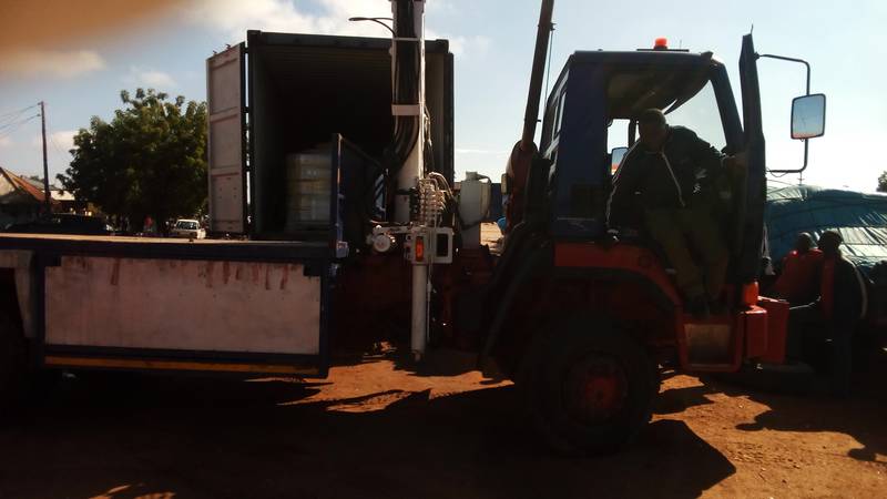 Using the hoist on the truck to offload the compressors