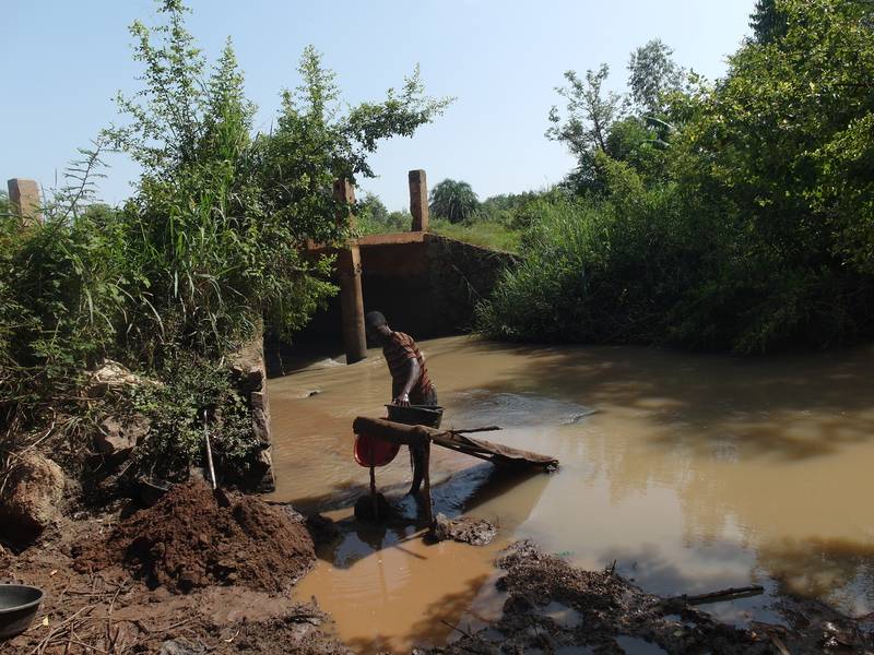 Person processing soil on the river Okame in Uganda