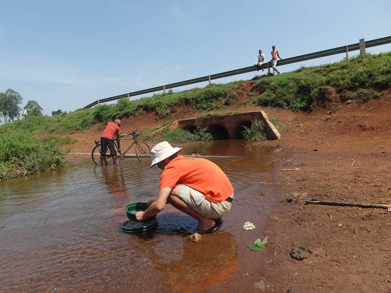 Mr. Louis assaying the soil on the stream