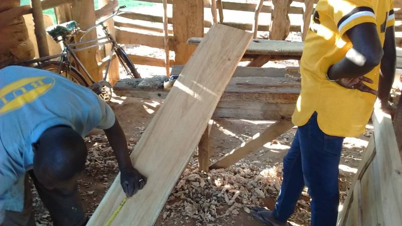 Carpenter choosing proper wooden boards