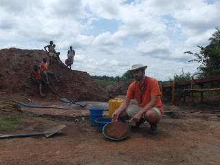 Children in background of Mr. Louis showing quantity of material in the gold pan