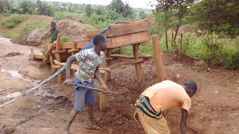 Children feeding the gold washing sluice in Uganda