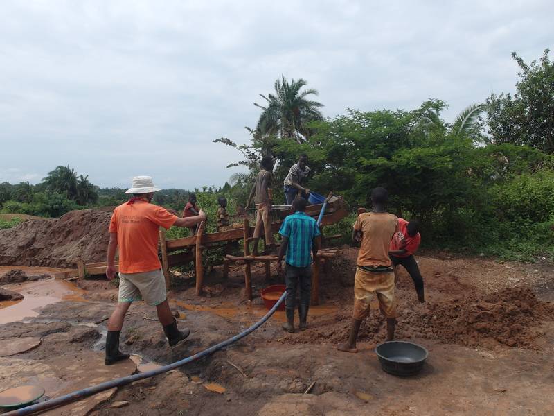 Children washing on the mining site, Mr. Louis attempting to advise them