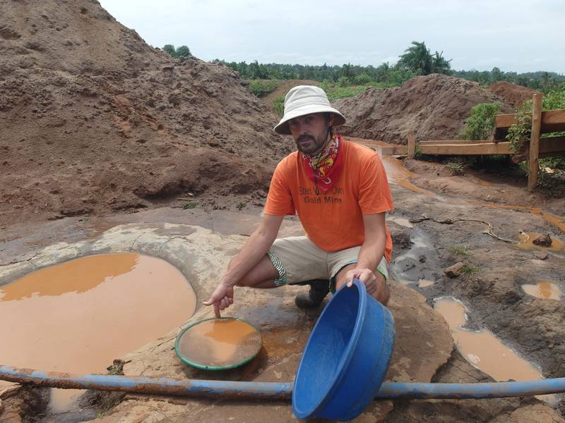 Mr. Louis showing one quantity of material for field assaying