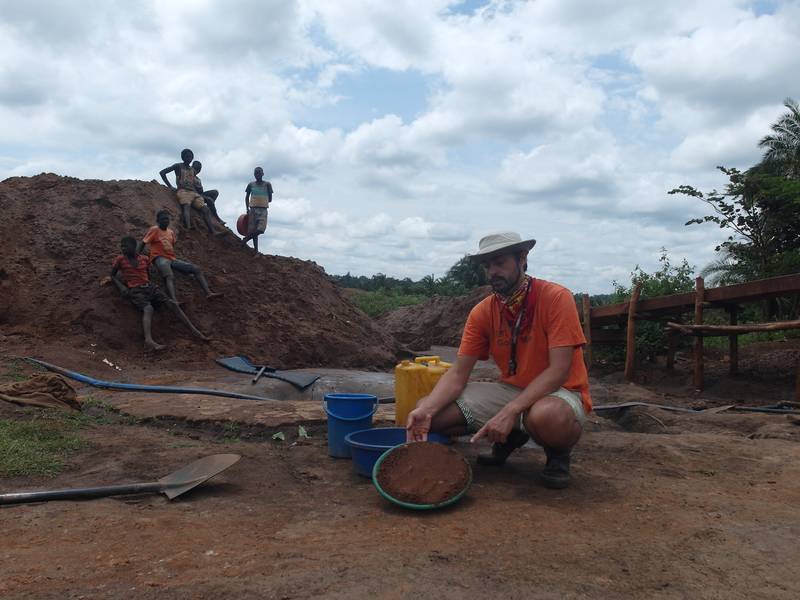 Children in background of Mr. Louis showing quantity of material in the gold pan