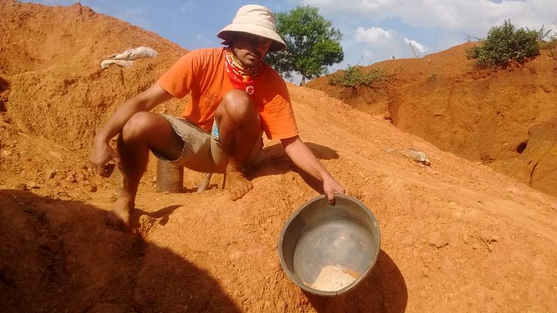 Mr. Louis showing the crushed rocks in the basin