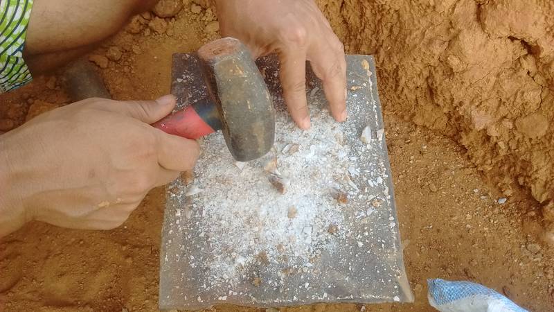 Crushing rocks while prospecting for gold