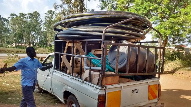 Loading 150 meter of 2 inch HDPE pipe onto the pick-up truck