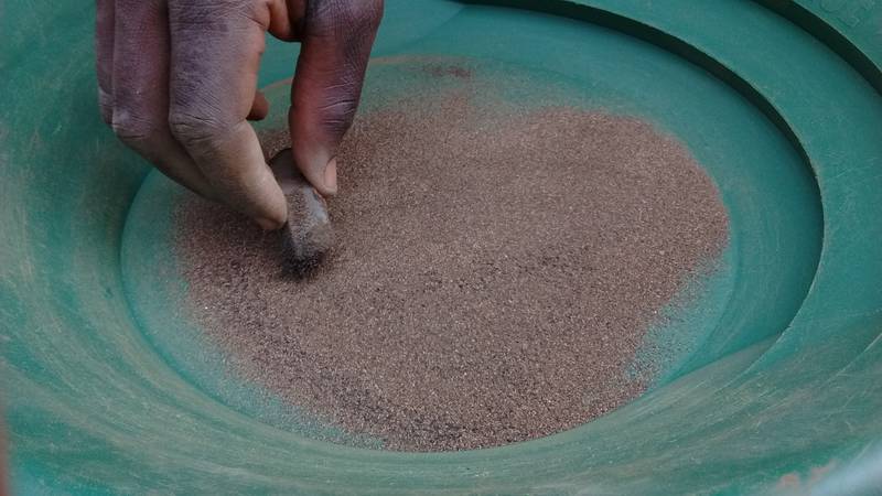 Collecting black sand with neodymium magnet