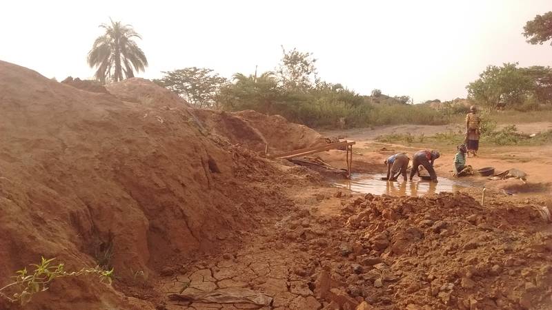 Women and people panning for gold nearby our tailings heaps