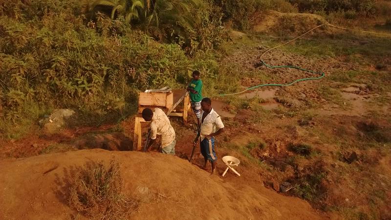 Miners working on the sluice