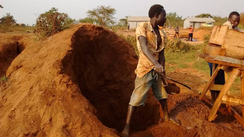 Mr. Okedi feeding the sluice