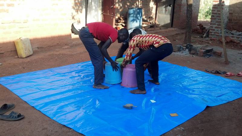 Placement of sample from sample buckets into the middle of plastic canvas