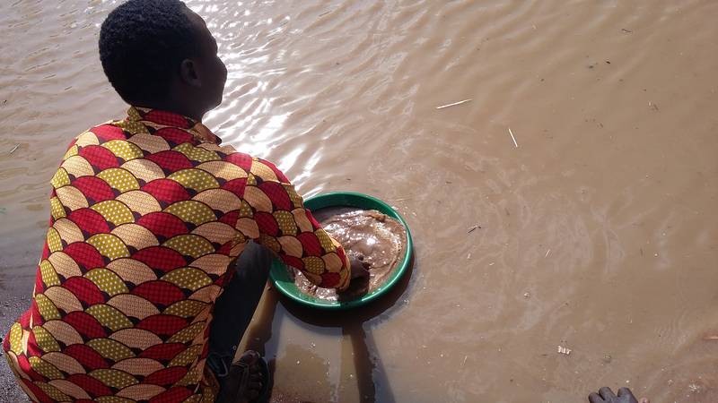 Wabwire gold panning on river Okame, Busia, Uganda