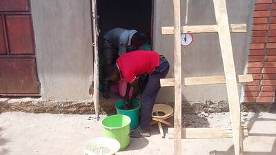 Staff members in Uganda are preparing the concentrate samples